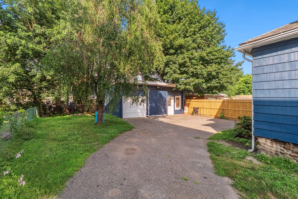 26 Olivine Street Chicopee, MA 01013 - Photo 23 of 26 a front view of a house with a yard and a tree