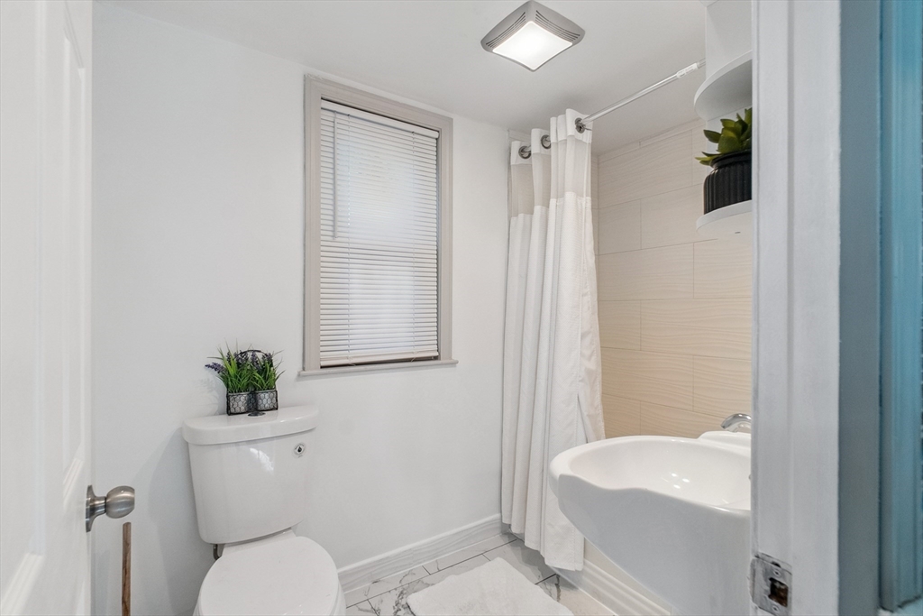 26 Olivine Street Chicopee, MA 01013 - Photo 24 of 26 a bathroom with a sink a toilet and shower