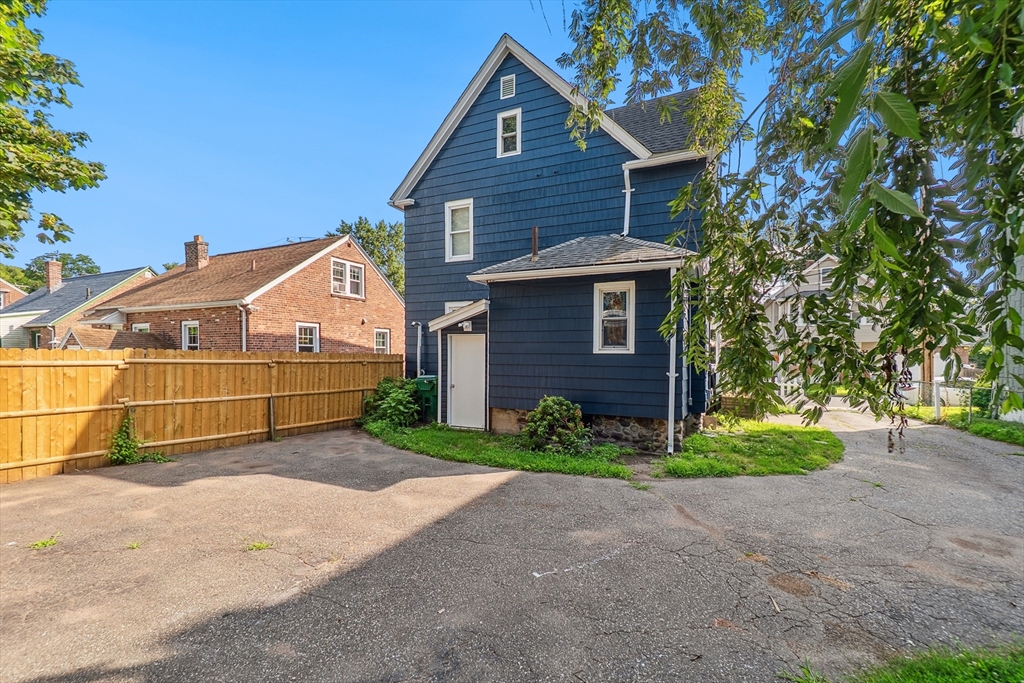 26 Olivine Street Chicopee, MA 01013 - Photo 26 of 26 a view of a house with a small yard and large trees
