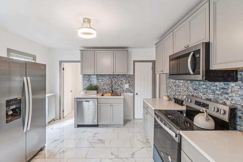 26 Olivine Street Chicopee, MA 01013 - Photo 6 of 26 a kitchen with stainless steel appliances granite countertop a sink stove and refrigerator