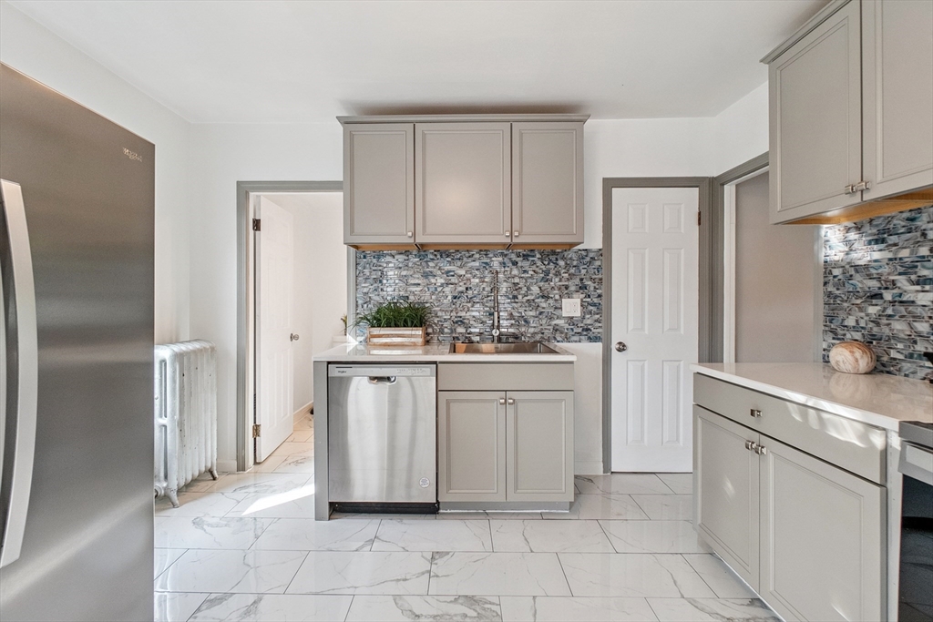 26 Olivine Street Chicopee, MA 01013 - Photo 10 of 26 a kitchen with white cabinets and refrigerator
