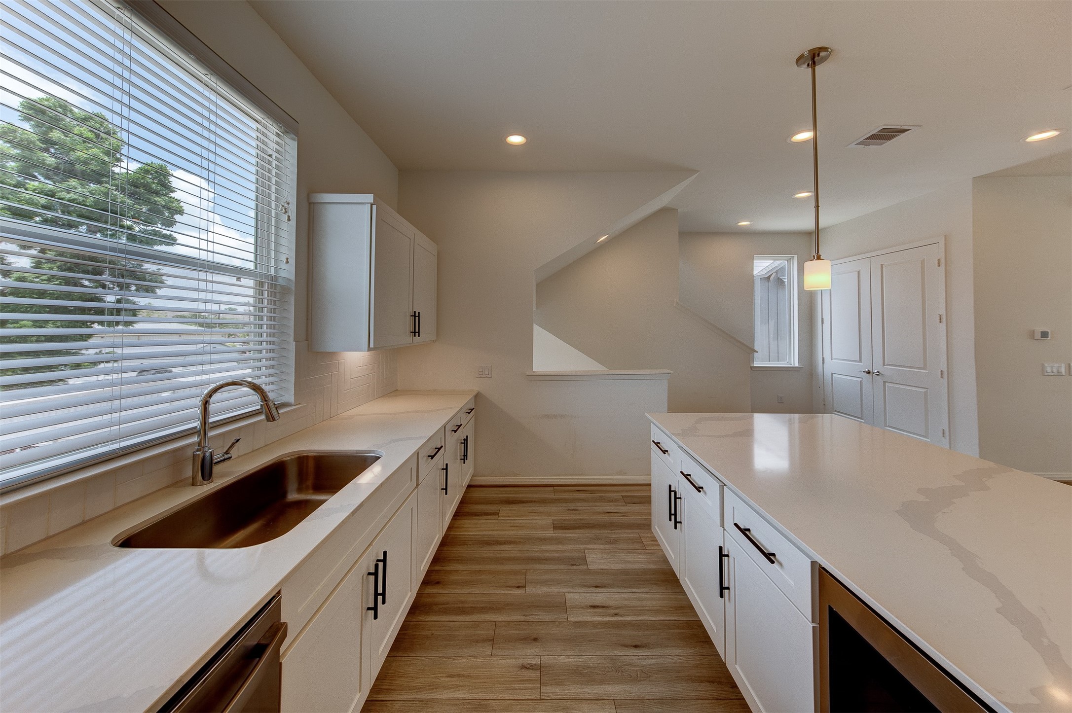 1526 Ojeman Road, Unit A Houston, TX 77055 - Photo 24 of 34 a kitchen with granite countertop a sink and a wooden floor
