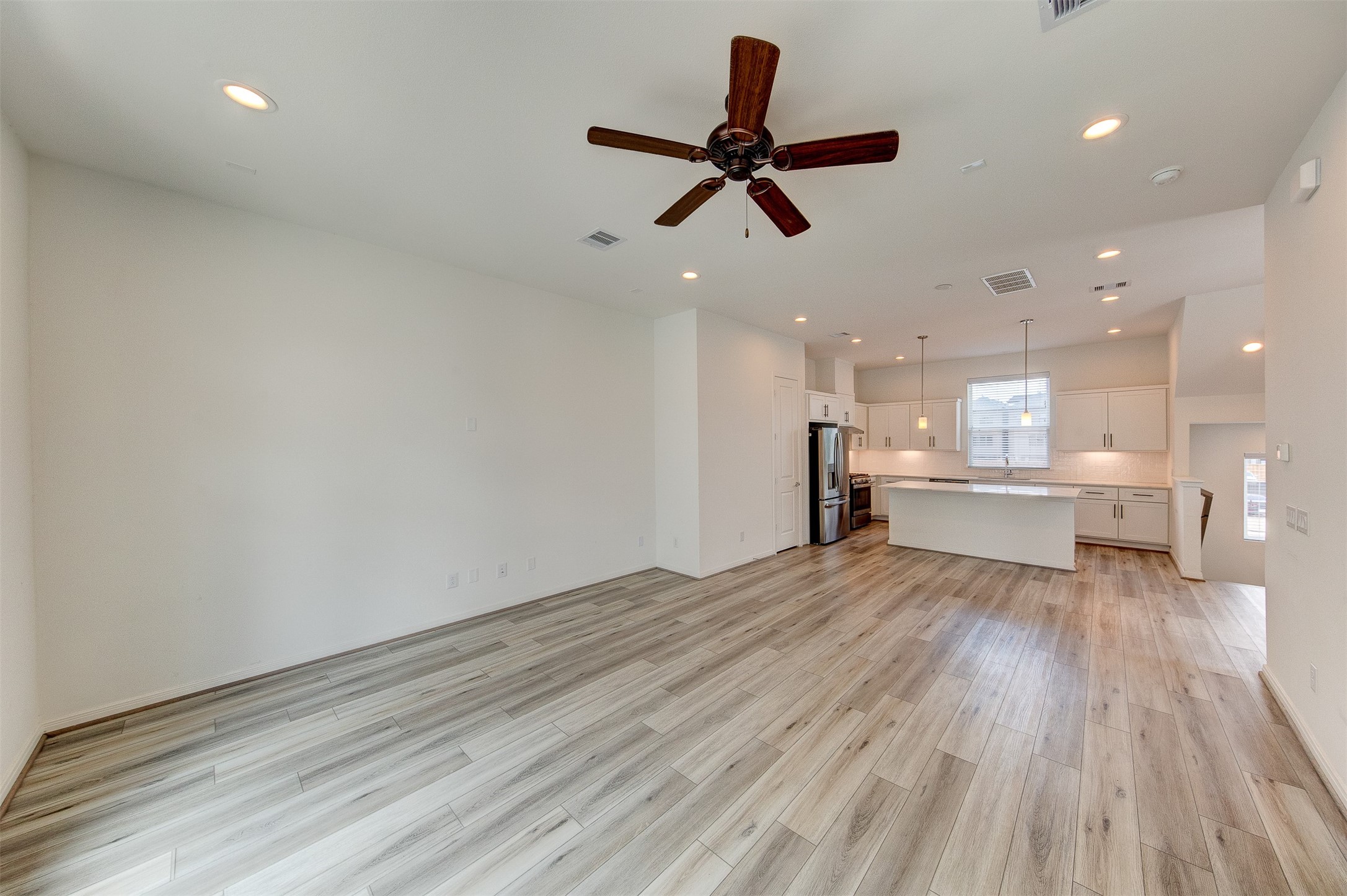 1526 Ojeman Road, Unit A Houston, TX 77055 - Photo 32 of 34 a view of a livingroom with a ceiling fan and wooden floor