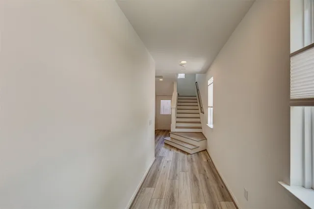 a view of entryway and hall with wooden floor