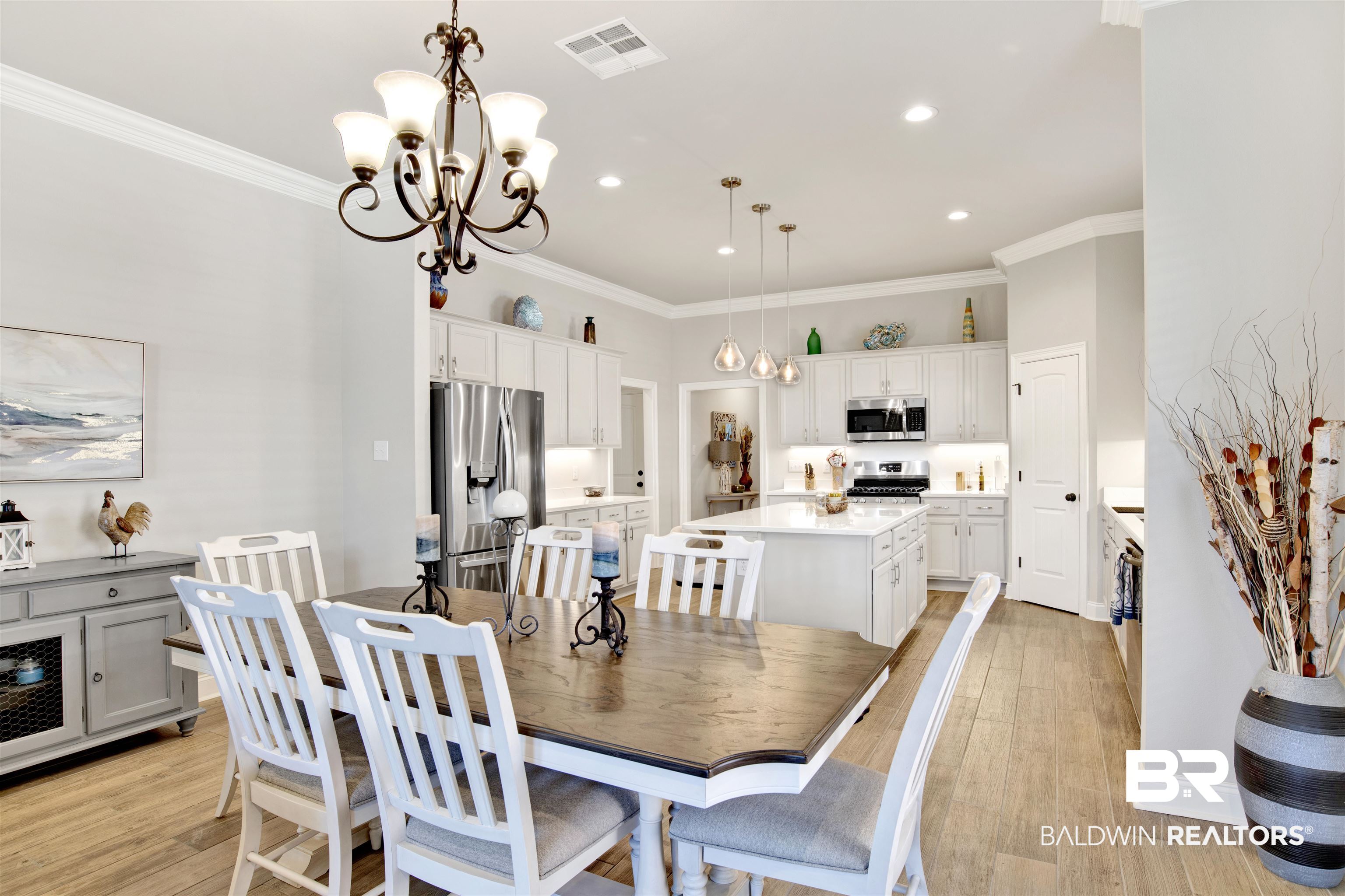 1406 Aldon Street Foley, AL 36535 - Photo 9 of 30 Dining room with an inviting chandelier, ornamental molding, and luxury wood-look tile flooring.