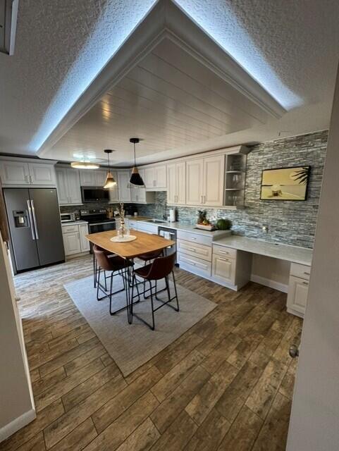 1509 15th Court Jupiter, FL 33477 - Photo 5 of 19 a kitchen with a table chairs microwave and cabinets