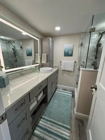 a spacious bathroom with double vanity and a mirror