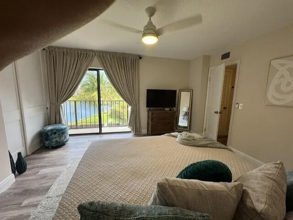 a bedroom with a bed and a large window