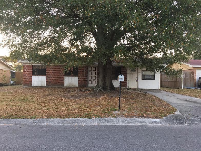 4913 Carlyle Road Tampa, FL 33615 - Photo 1 of 1 a front view of a house with a yard and garage