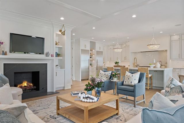 a kitchen with stainless steel appliances kitchen island granite countertop a refrigerator and a stove top oven