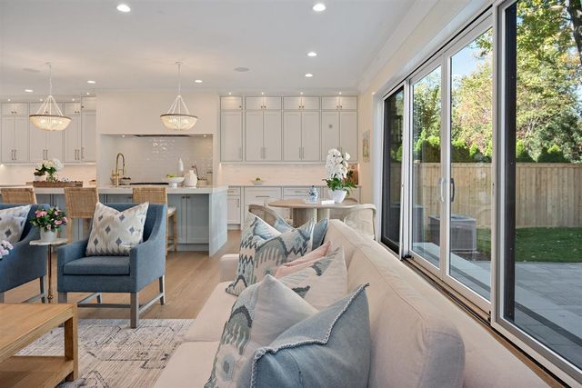 a kitchen with white cabinets and refrigerator