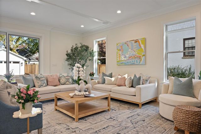 a dining room with furniture a potted plant and a chandelier