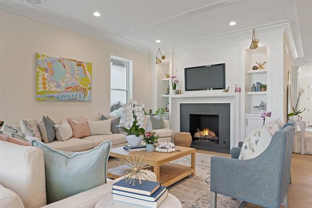 a living room with a large window and furniture