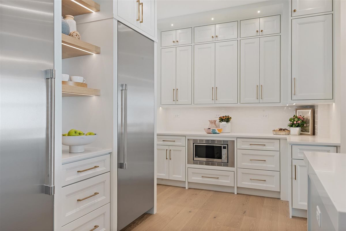 889 Cherry Street Winnetka, IL 60093 - Photo 17 of 76 a kitchen with white cabinets and refrigerator