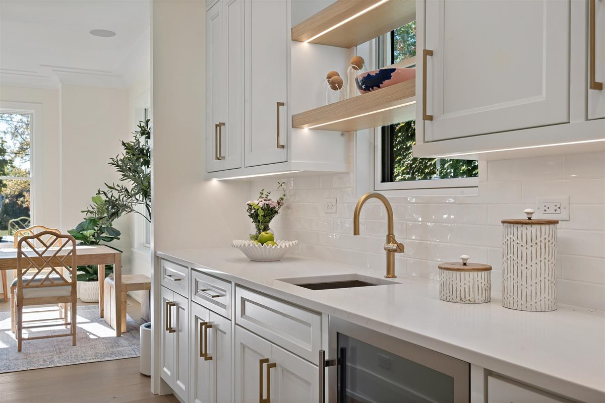 889 Cherry Street Winnetka, IL 60093 - Photo 19 of 76 a kitchen with kitchen island a sink and white cabinets