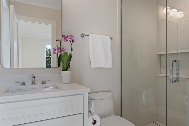 a bathroom with a toilet a sink and a shower