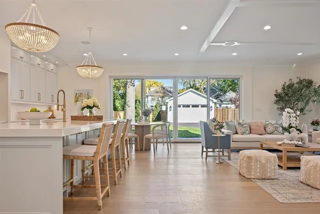a kitchen with stainless steel appliances kitchen island granite countertop a refrigerator and a stove top oven