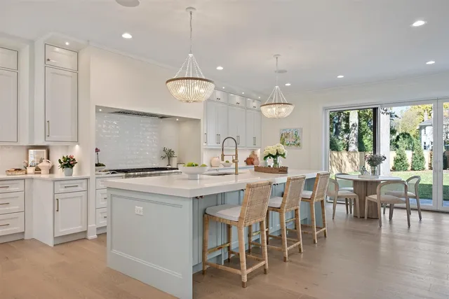 a kitchen with white cabinets and refrigerator