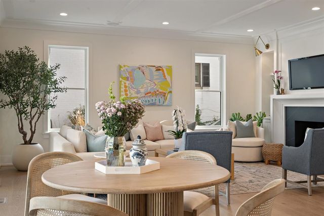 a living room with furniture potted plant and window
