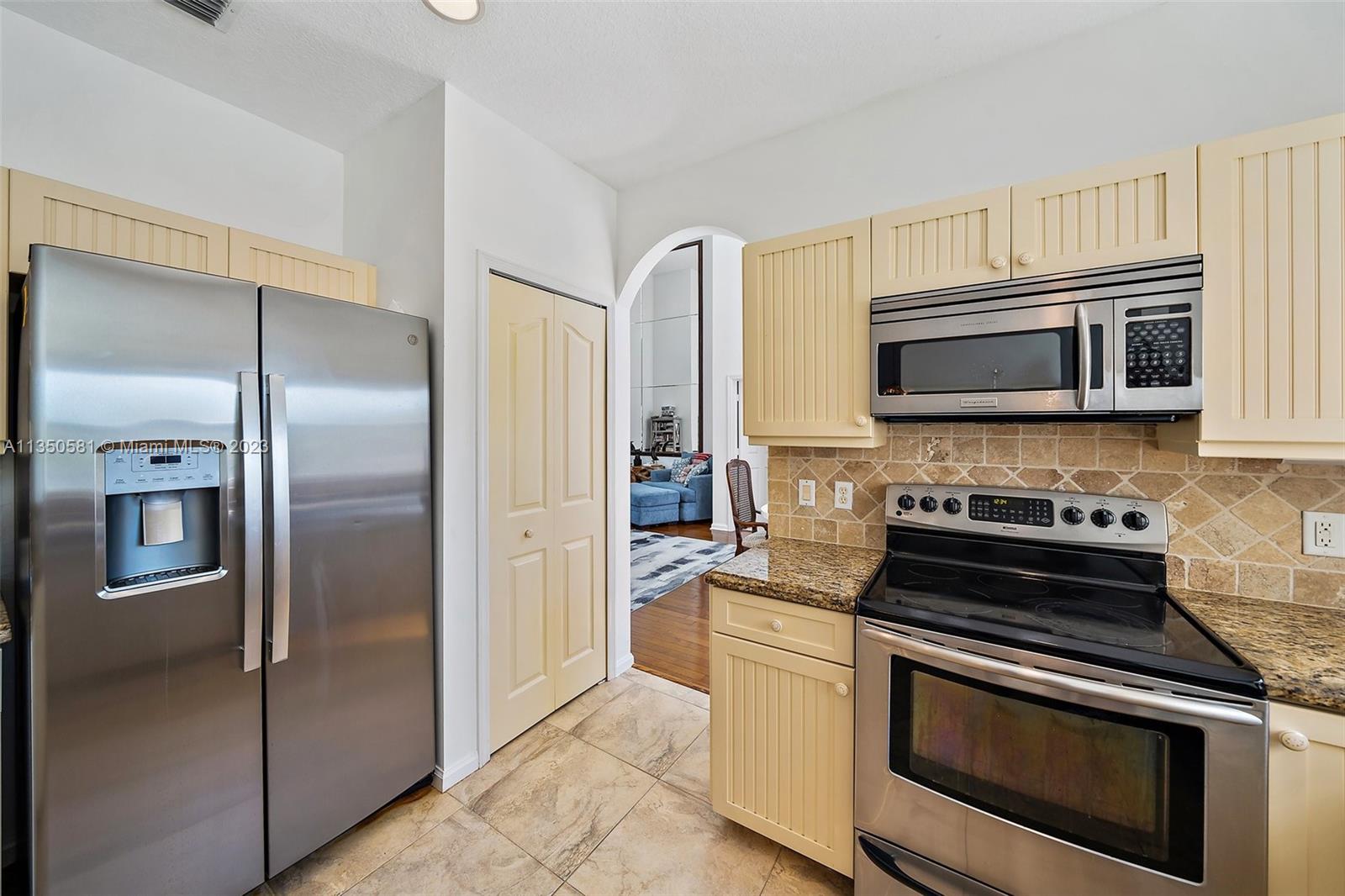 32 Coconut Lane Tequesta, FL 33469 - Photo 16 of 56 a kitchen with stainless steel appliances granite countertop a refrigerator stove and microwave