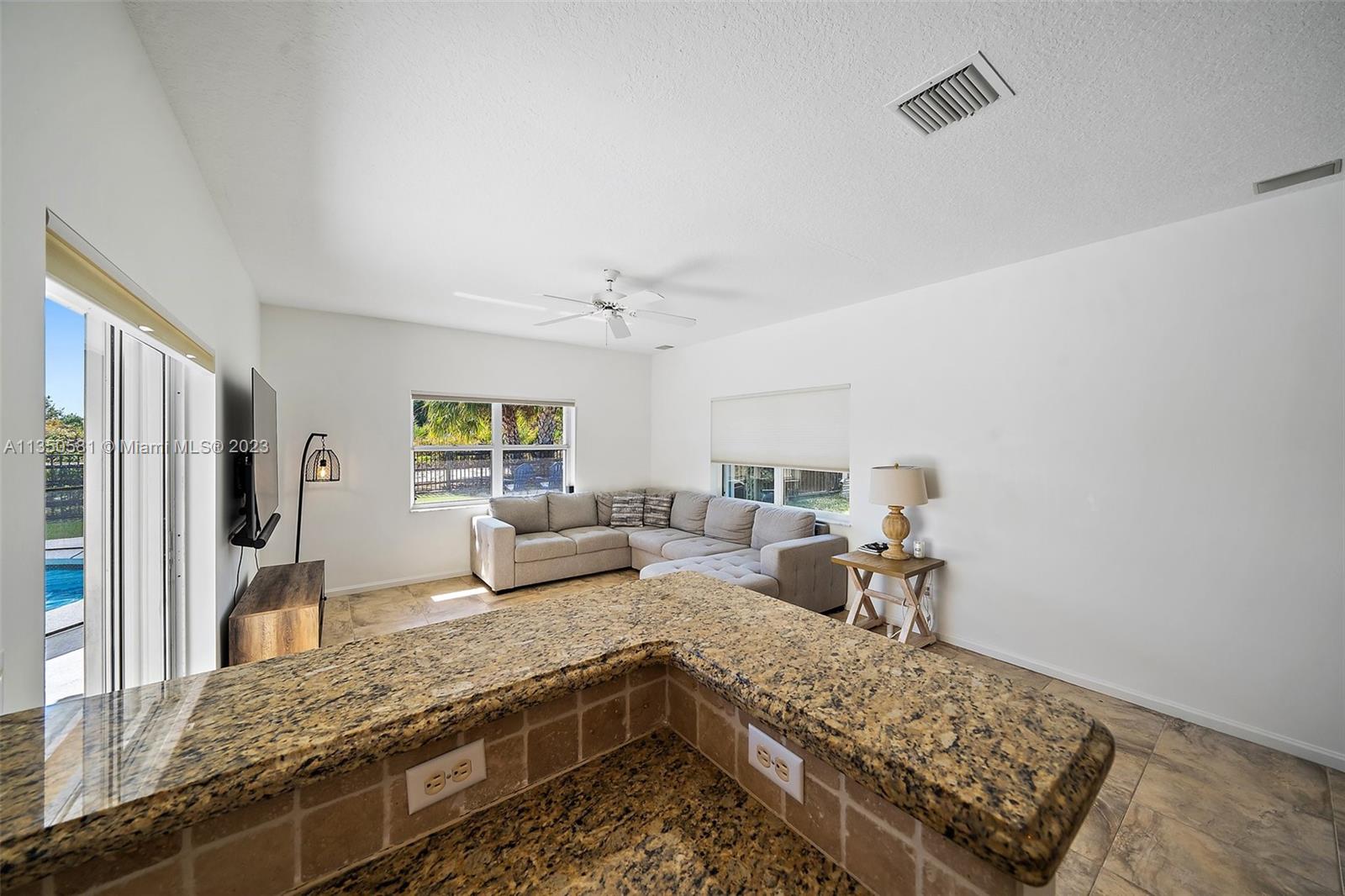 32 Coconut Lane Tequesta, FL 33469 - Photo 19 of 56 a living room with stainless steel appliances granite countertop furniture and a couch
