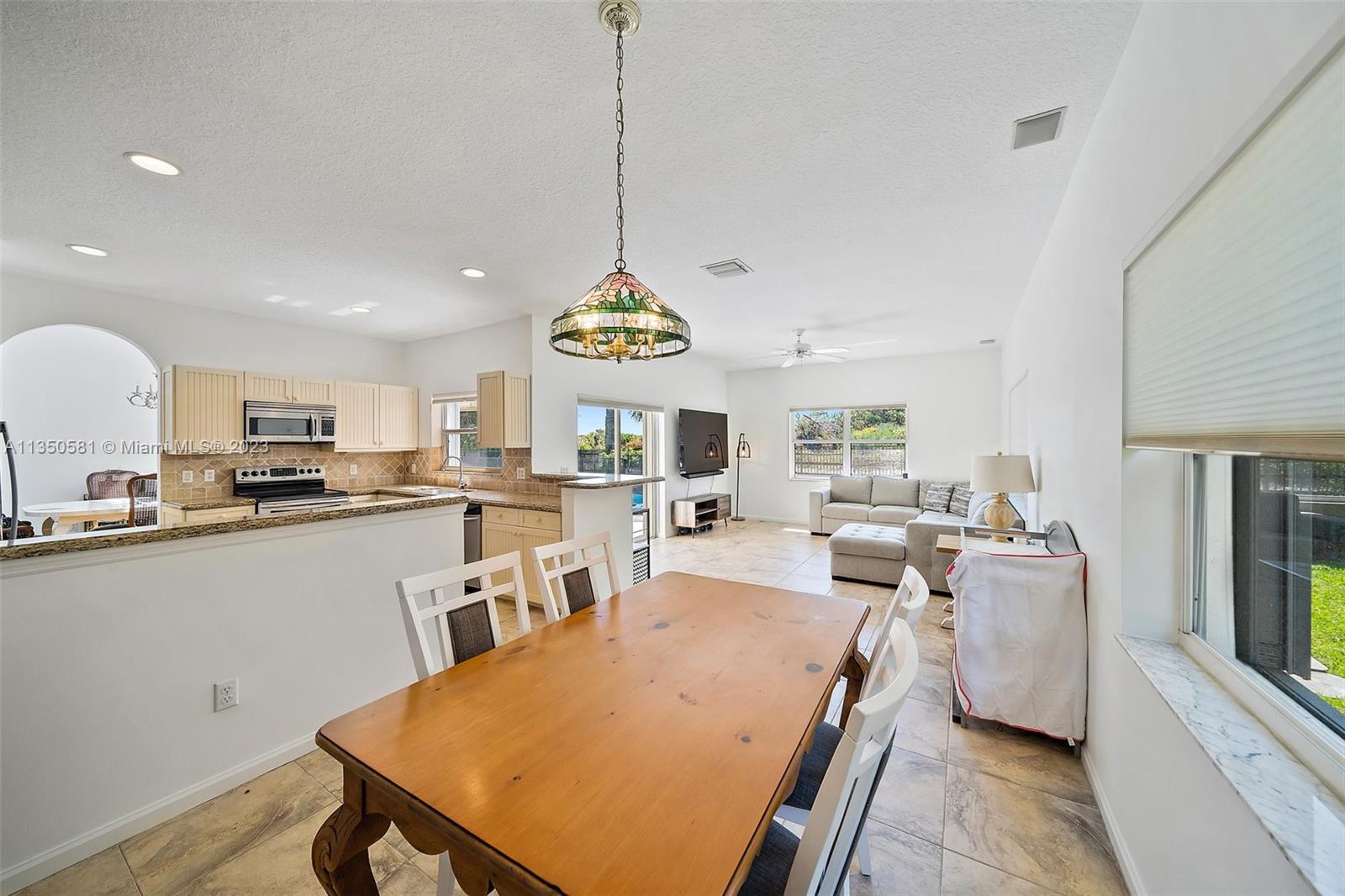 32 Coconut Lane Tequesta, FL 33469 - Photo 20 of 56 a view of a dining room with furniture window and wooden floor