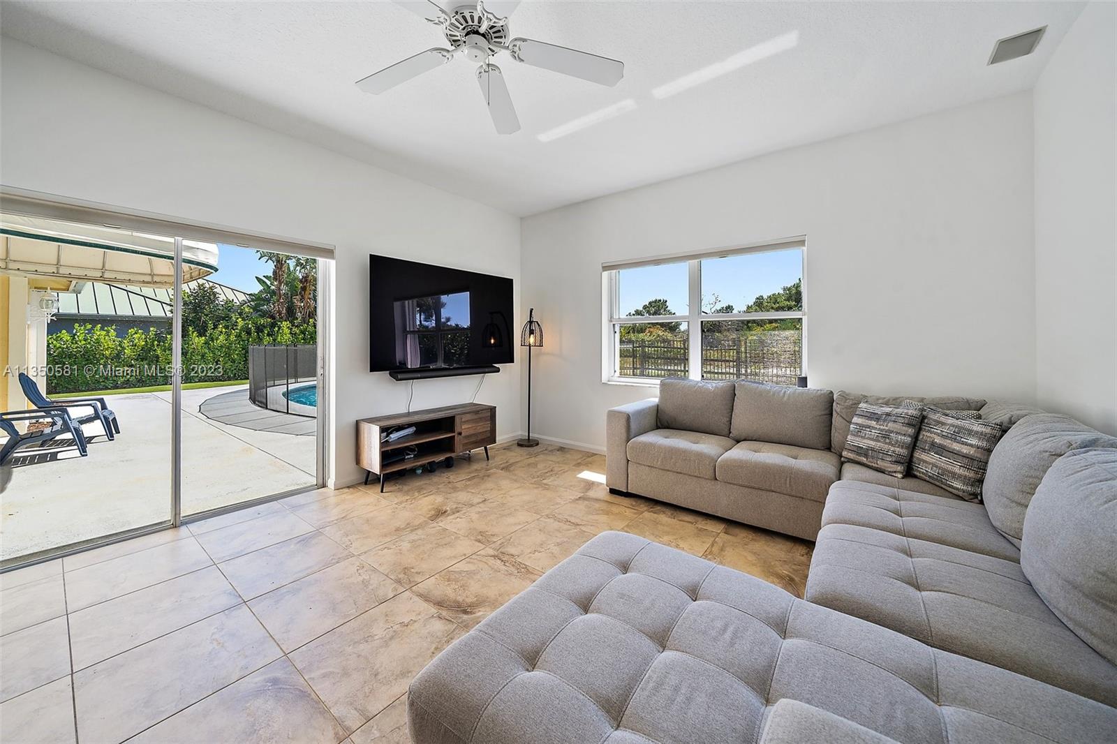 32 Coconut Lane Tequesta, FL 33469 - Photo 22 of 56 a living room with furniture a flat screen tv and a large window