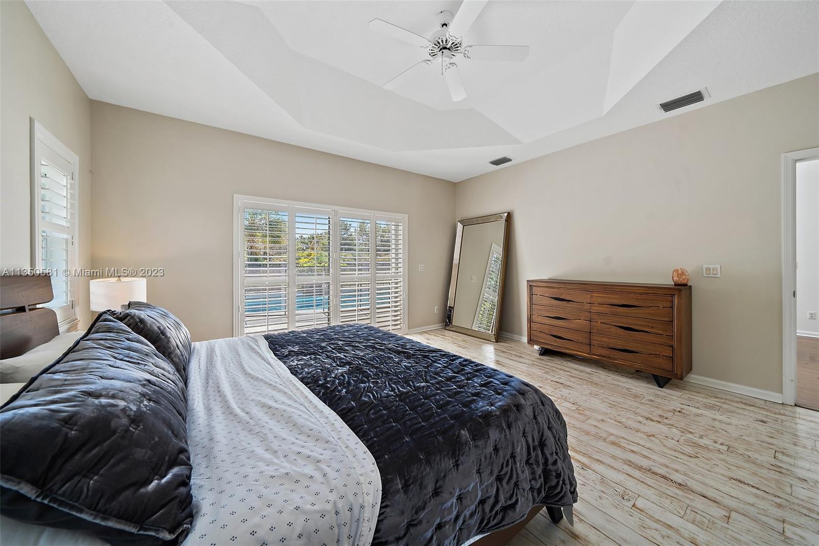 32 Coconut Lane Tequesta, FL 33469 - Photo 26 of 56 a bedroom with a bed a dresser and a window