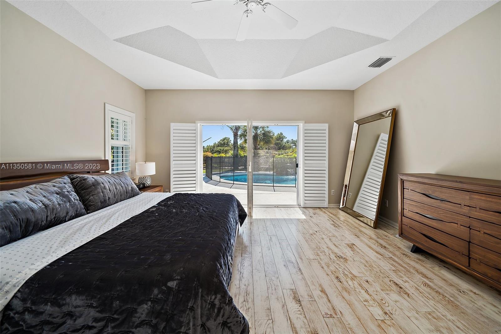 32 Coconut Lane Tequesta, FL 33469 - Photo 27 of 56 a bedroom with a bed and a large window