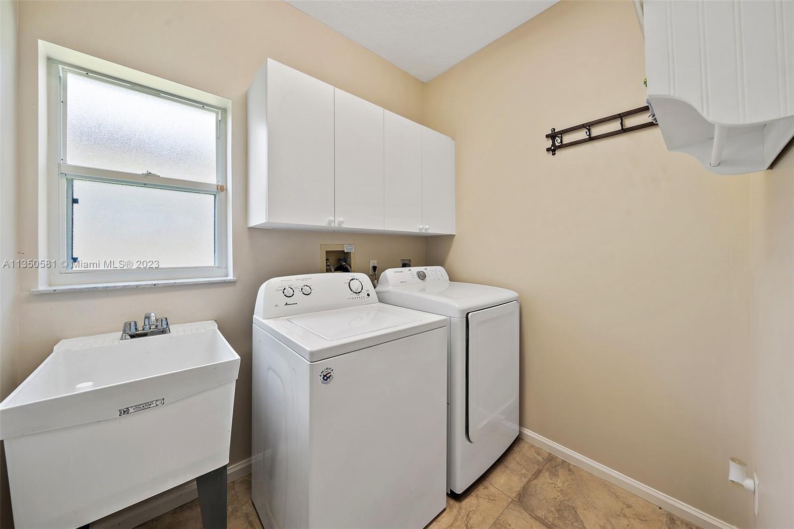 32 Coconut Lane Tequesta, FL 33469 - Photo 30 of 56 a utility room with dryer and washer