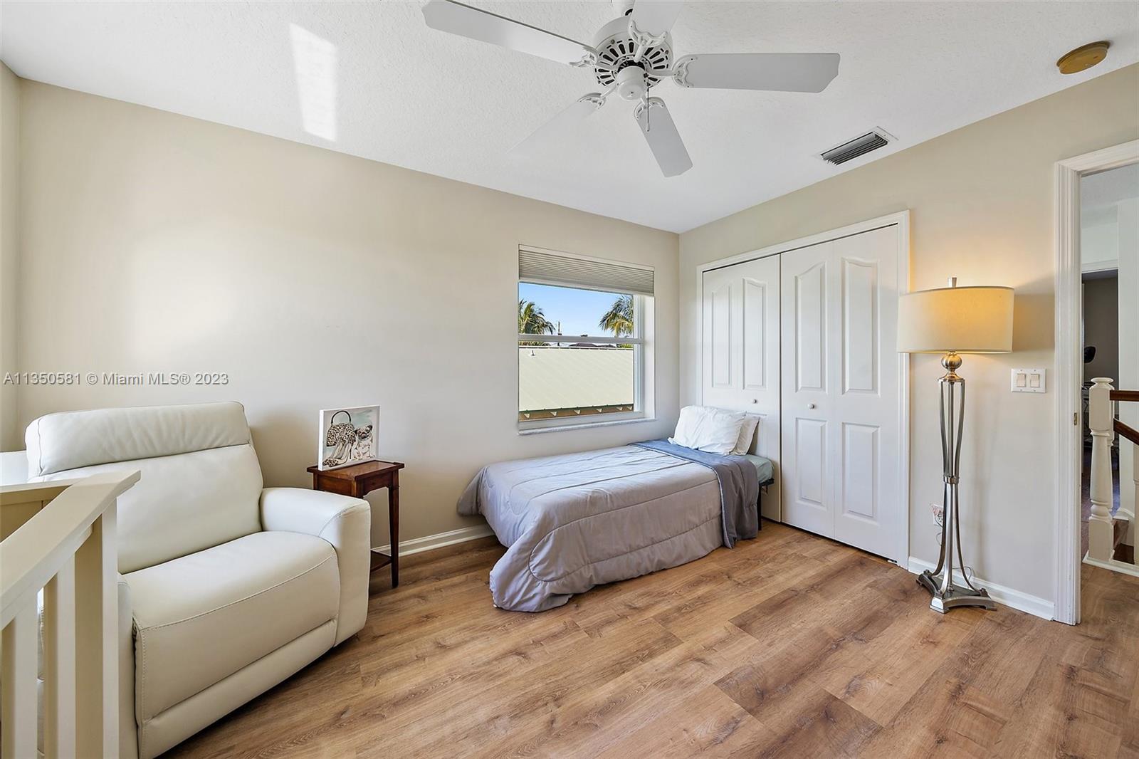 32 Coconut Lane Tequesta, FL 33469 - Photo 33 of 56 a spacious bedroom with a bed a couch and a chandelier