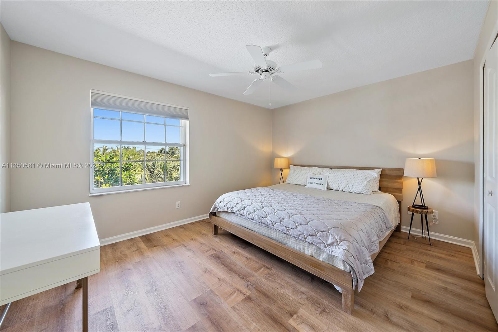 32 Coconut Lane Tequesta, FL 33469 - Photo 35 of 56 a bedroom with a large bed and a window