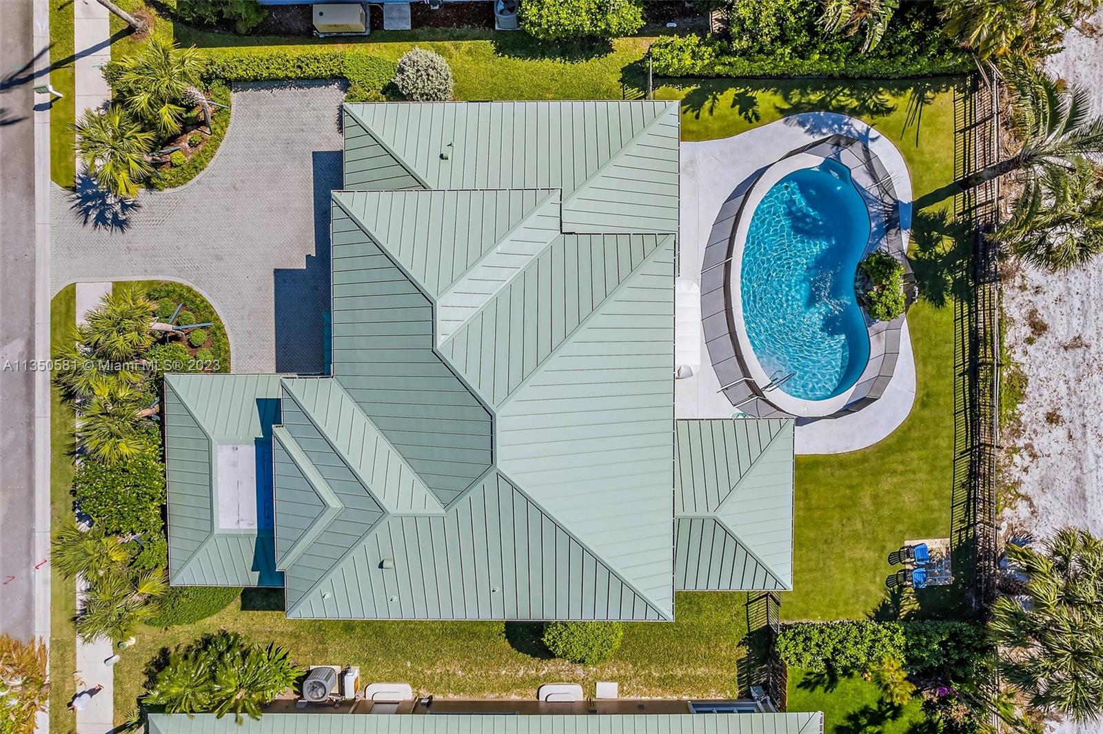 32 Coconut Lane Tequesta, FL 33469 - Photo 39 of 56 a view of a swimming pool with sitting area and garden
