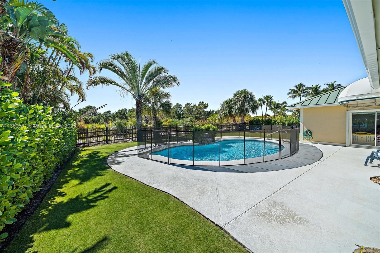 32 Coconut Lane Tequesta, FL 33469 - Photo 41 of 56 a view of a swimming pool with a yard