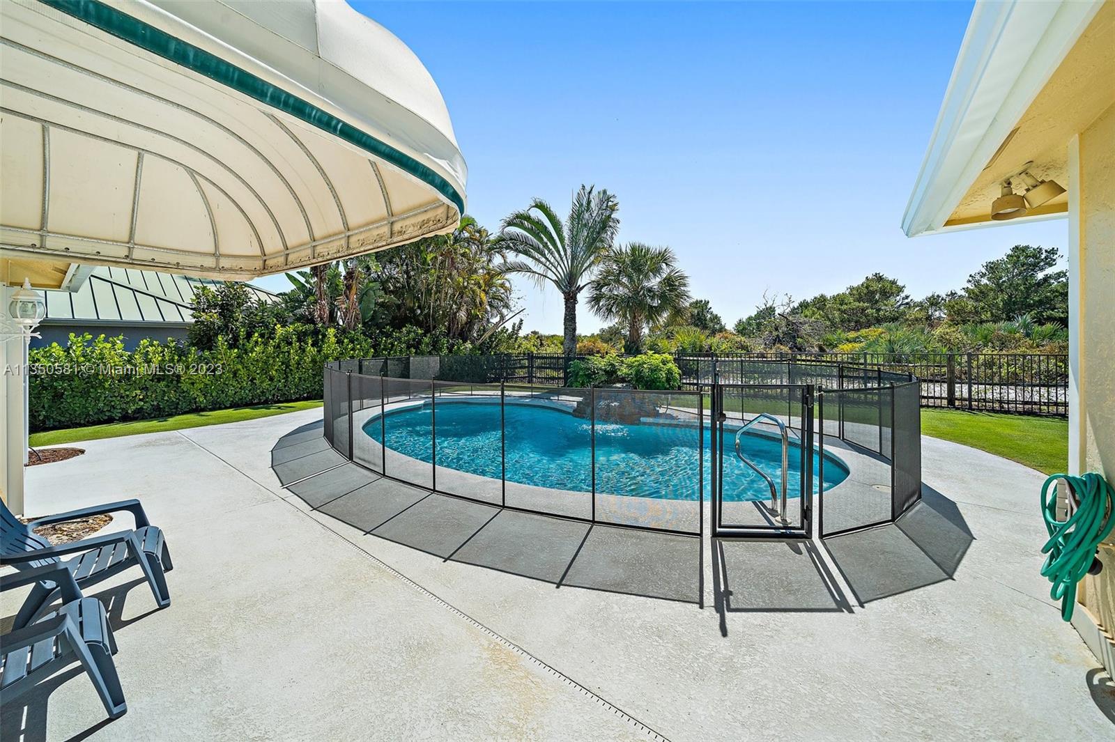 32 Coconut Lane Tequesta, FL 33469 - Photo 42 of 56 a view of a swimming pool with a lounge chairs