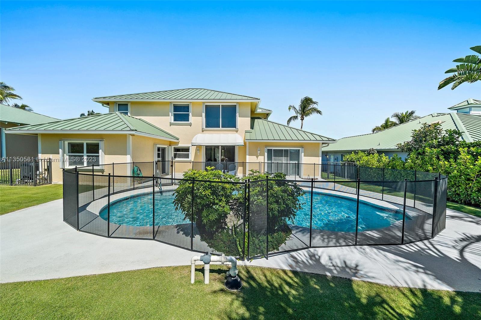 32 Coconut Lane Tequesta, FL 33469 - Photo 43 of 56 a front view of a house with a yard
