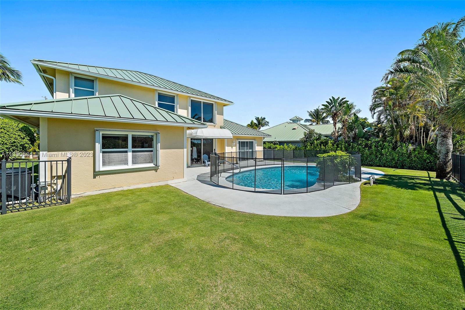 32 Coconut Lane Tequesta, FL 33469 - Photo 45 of 56 a view of a house with a backyard