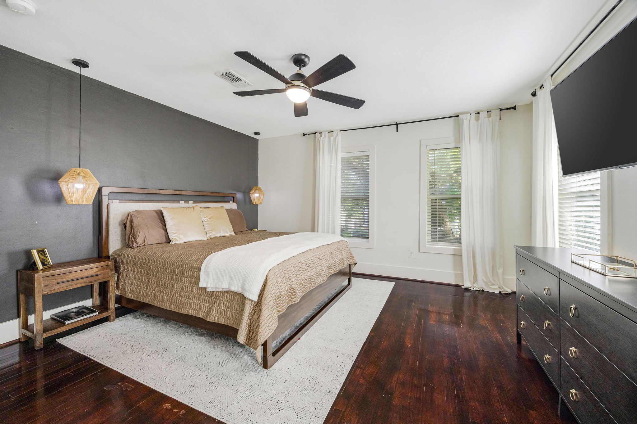 2613 Wichita Street Houston, TX 77004 - Photo 18 of 25 Spacious primary suite with hardwood floors, abundant natural light, and plenty of room to create a relaxing retreat.