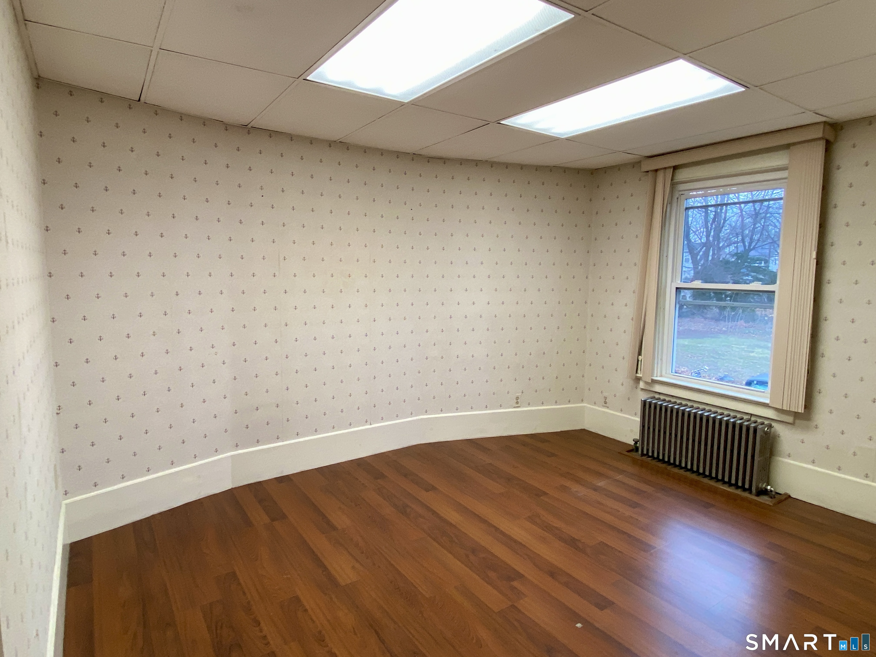 140 Union Street Vernon, CT 06066 - Photo 12 of 26 an empty room with wooden floor and windows