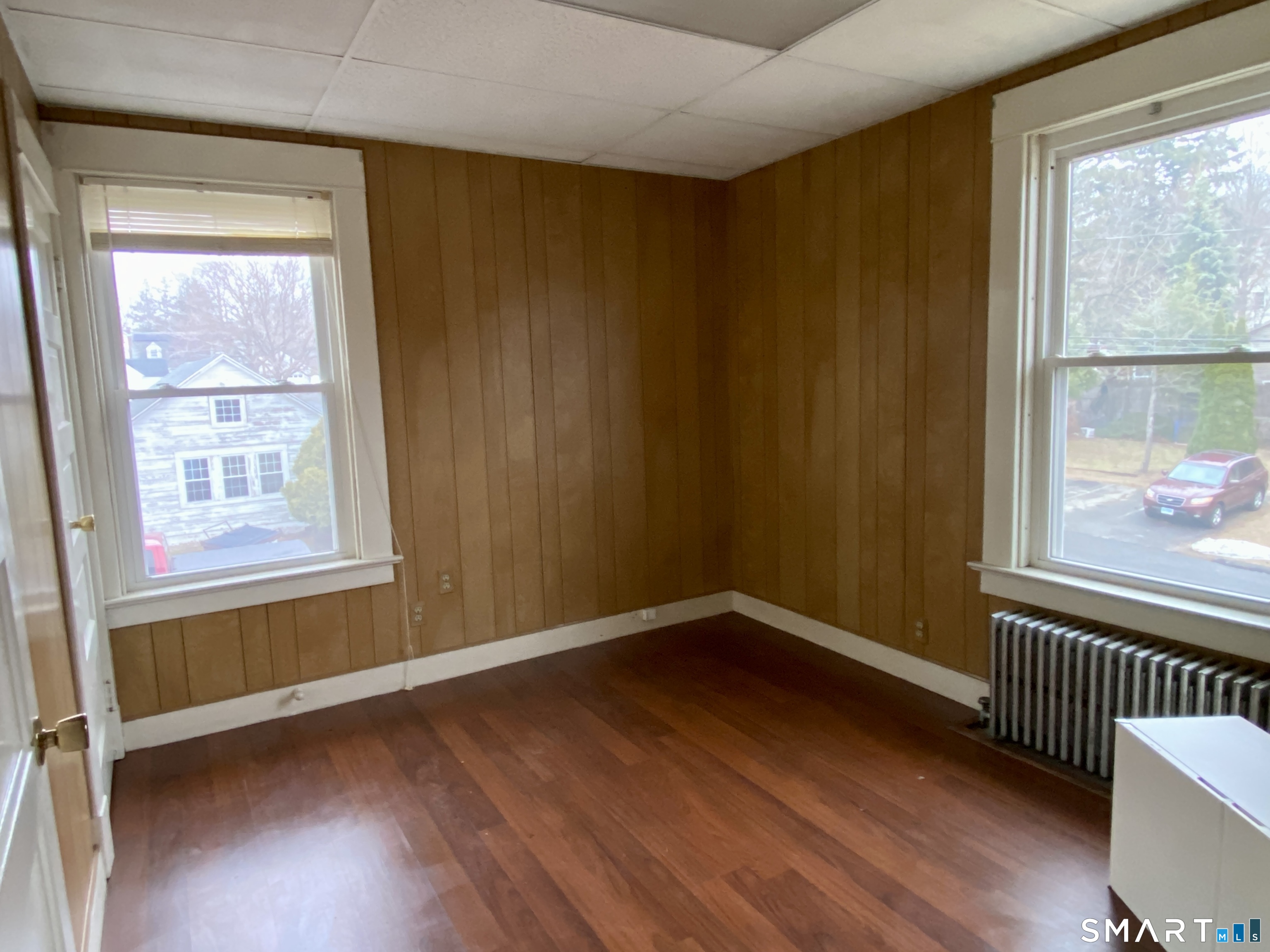 140 Union Street Vernon, CT 06066 - Photo 13 of 26 an empty room with wooden floor and windows