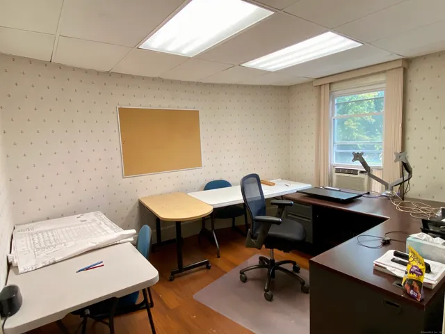 a bedroom with furniture and a window
