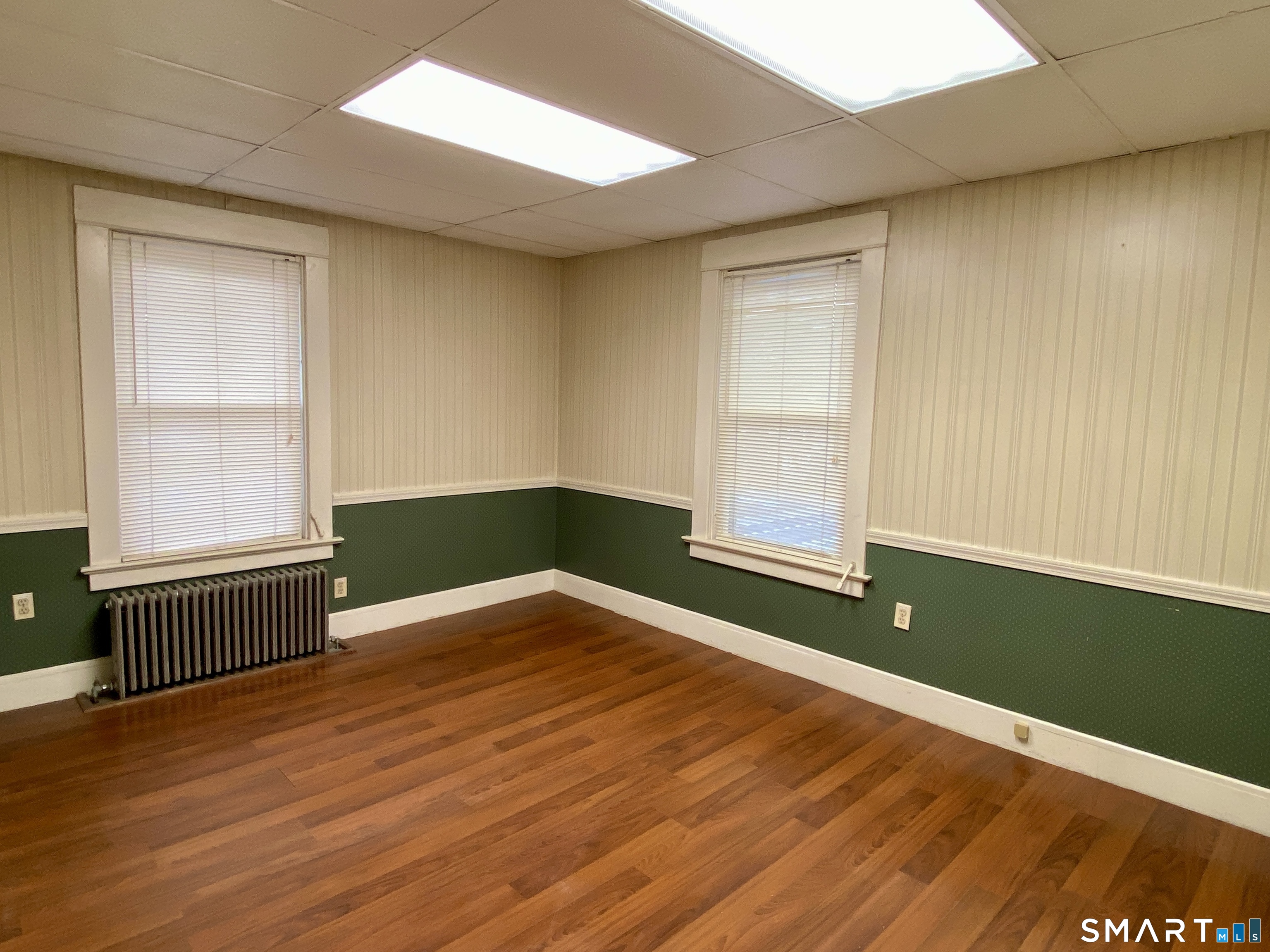 140 Union Street Vernon, CT 06066 - Photo 15 of 26 an empty room with wooden floor and windows