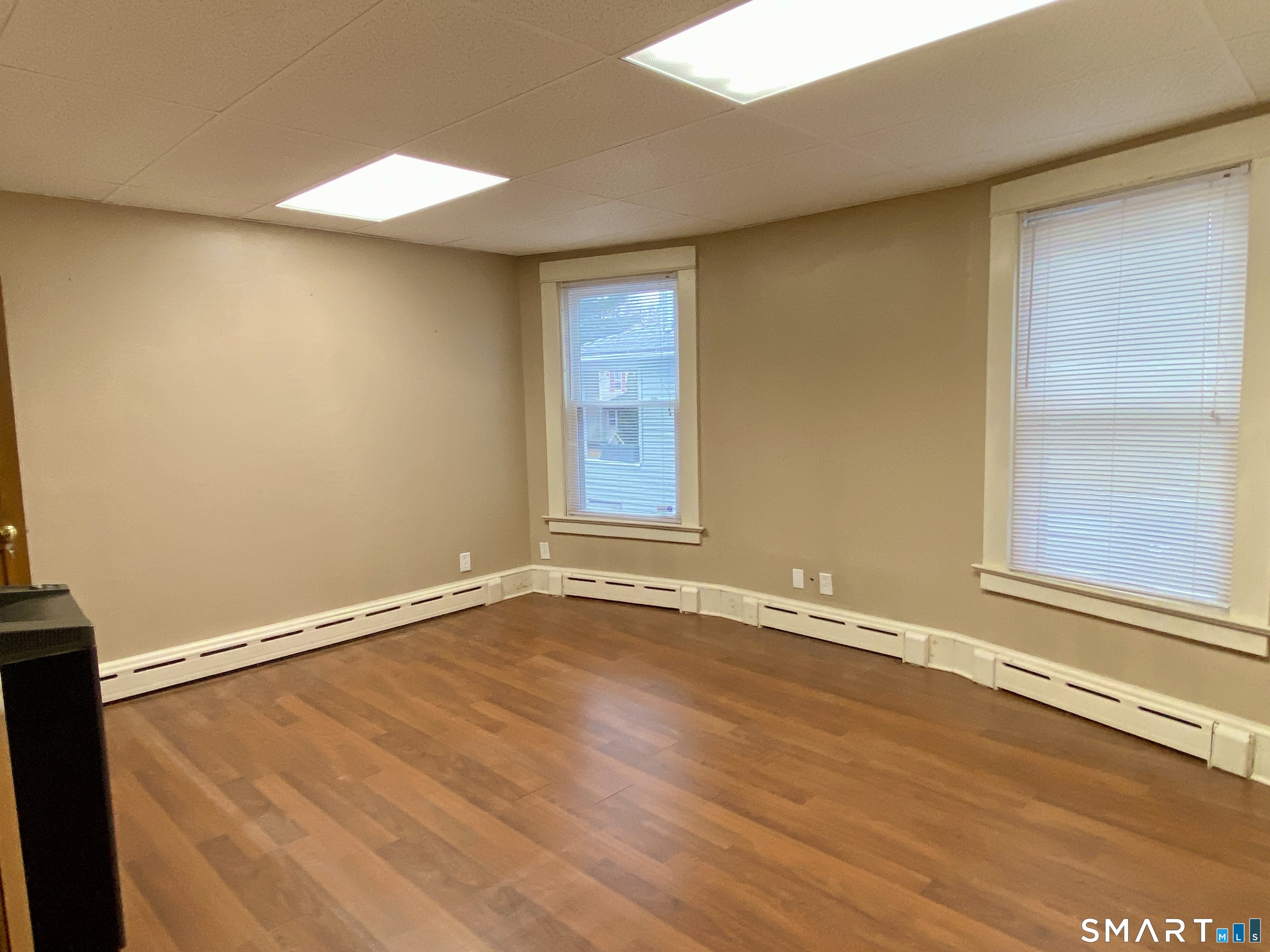 140 Union Street Vernon, CT 06066 - Photo 8 of 26 an empty room with a wooden floor and a window