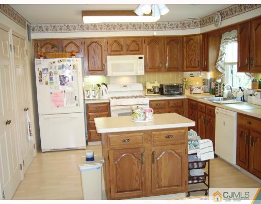 4201 Springbrook Drive Edison, NJ 08820 - Photo 4 of 8 a kitchen with kitchen island a stove a sink and a refrigerator
