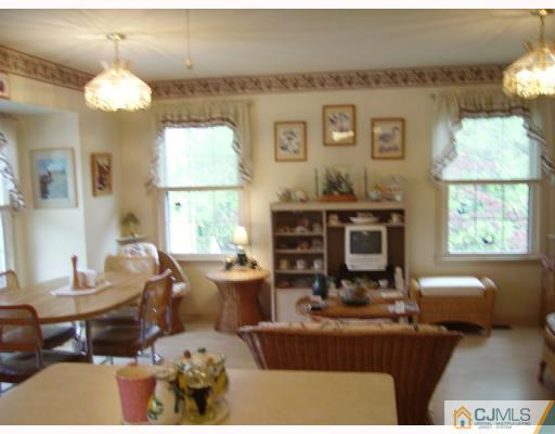 4201 Springbrook Drive Edison, NJ 08820 - Photo 5 of 8 a living room with furniture a window and a chandelier