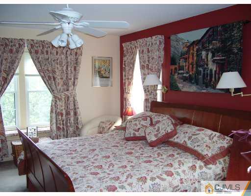 4201 Springbrook Drive Edison, NJ 08820 - Photo 8 of 8 a bedroom with a large bed and a chandelier