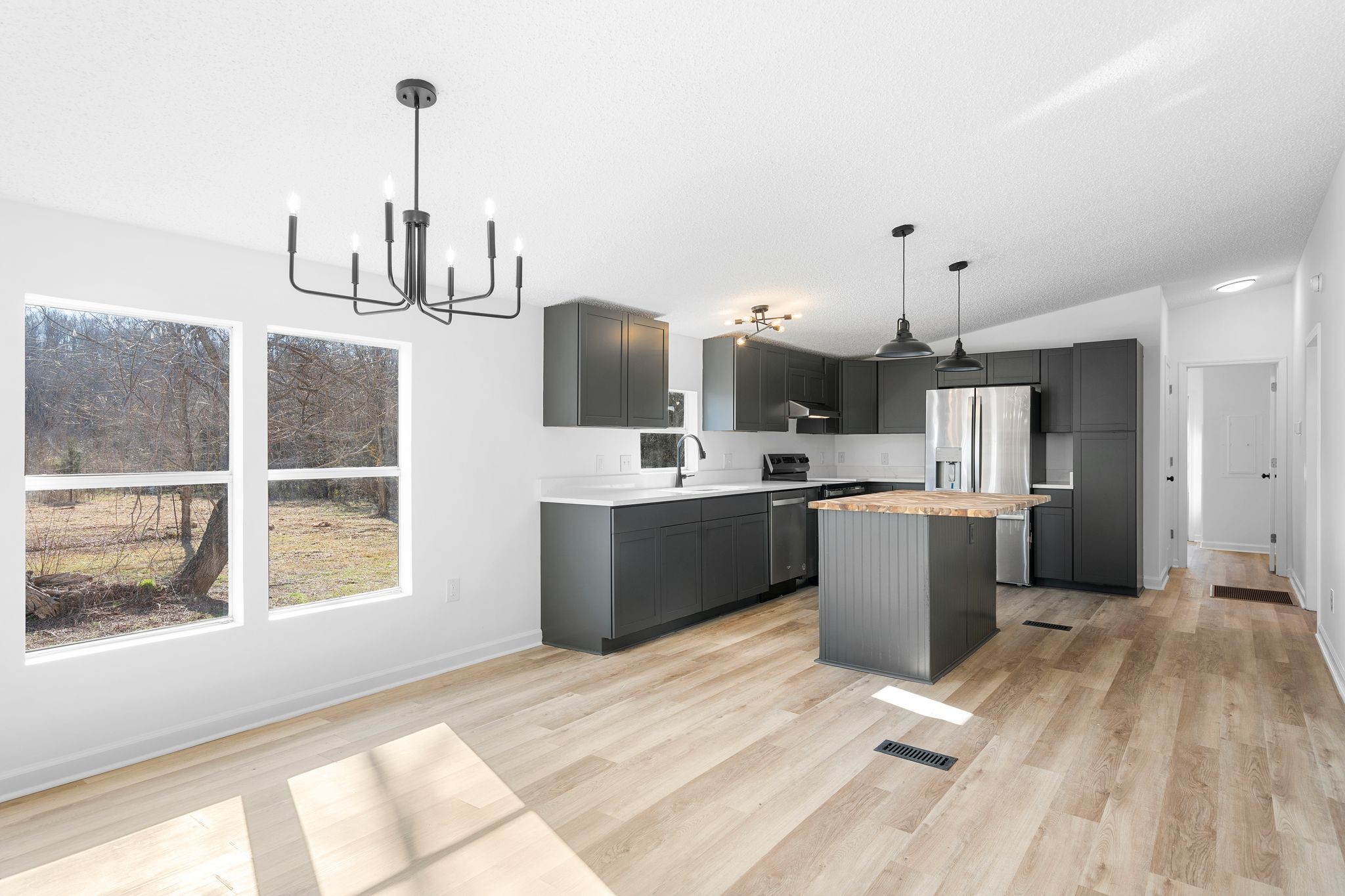 3092 McKibbon Road Culleoka, TN 38451 - Photo 22 of 41 a kitchen with stainless steel appliances kitchen island granite countertop a sink a counter space and cabinets