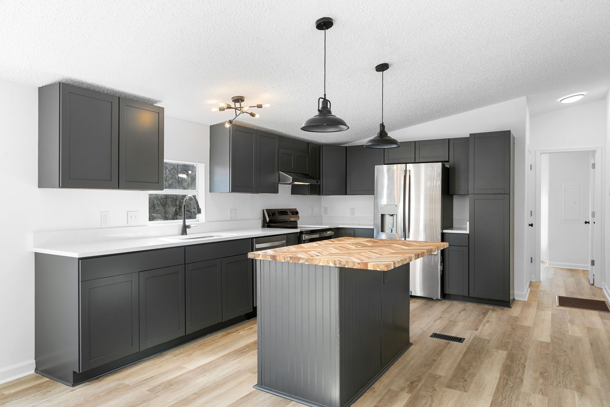 3092 McKibbon Road Culleoka, TN 38451 - Photo 23 of 41 a kitchen with stainless steel appliances granite countertop a sink stove and refrigerator