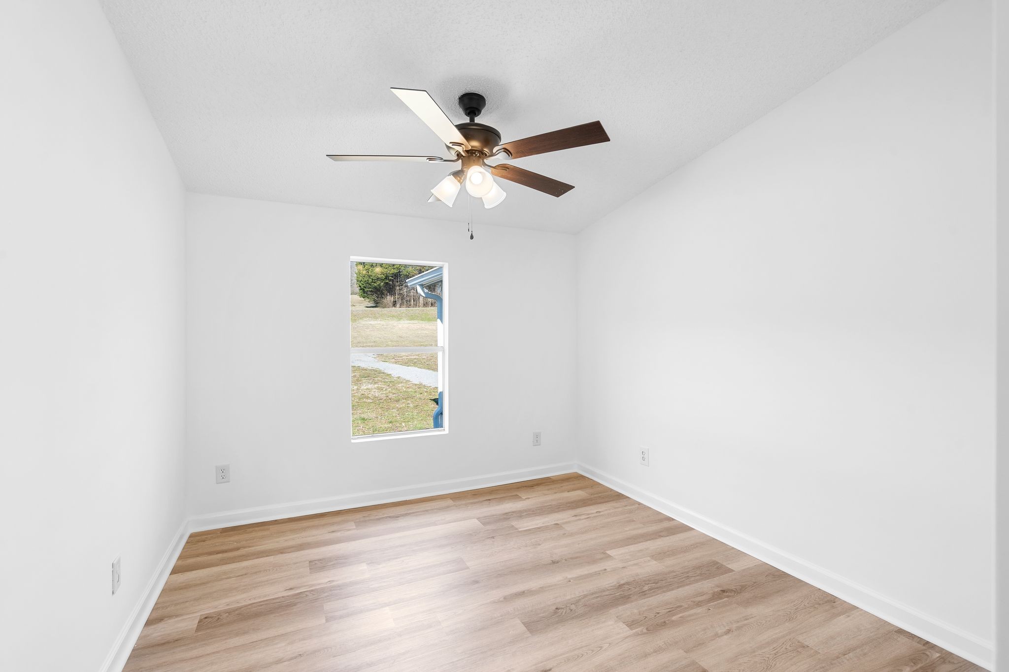 3092 McKibbon Road Culleoka, TN 38451 - Photo 36 of 41 an empty room with wooden floor fan and windows