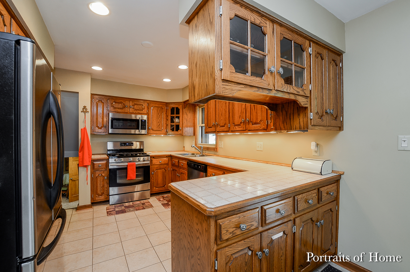 1805 South Tyler Road St. Charles, IL 60174 - Photo 4 of 17 a kitchen with stainless steel appliances a stove refrigerator sink and cabinets